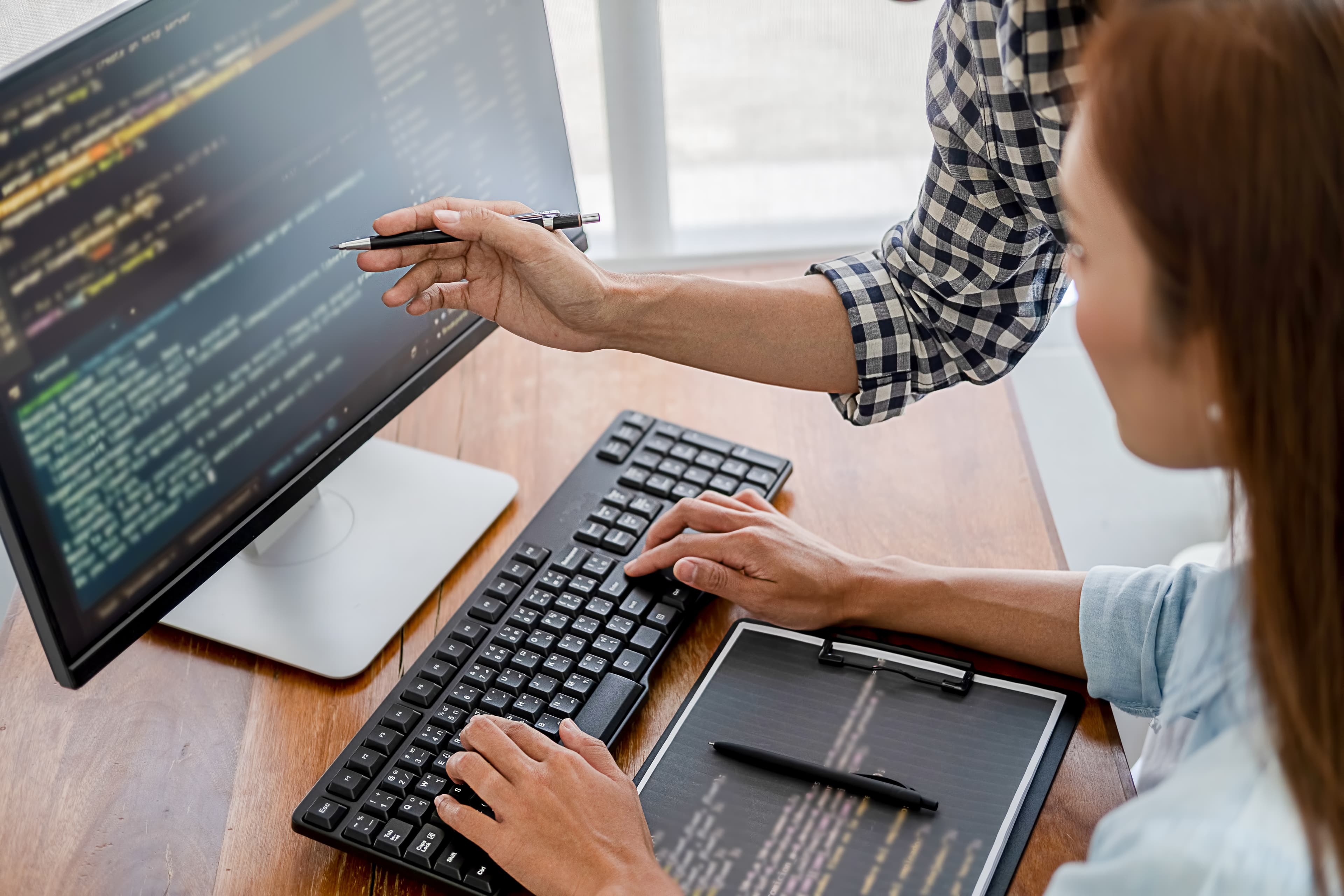 Femme tapant sur un clavier pour écrire et développer un langage informatique